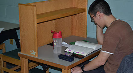 Man studying in a carrel